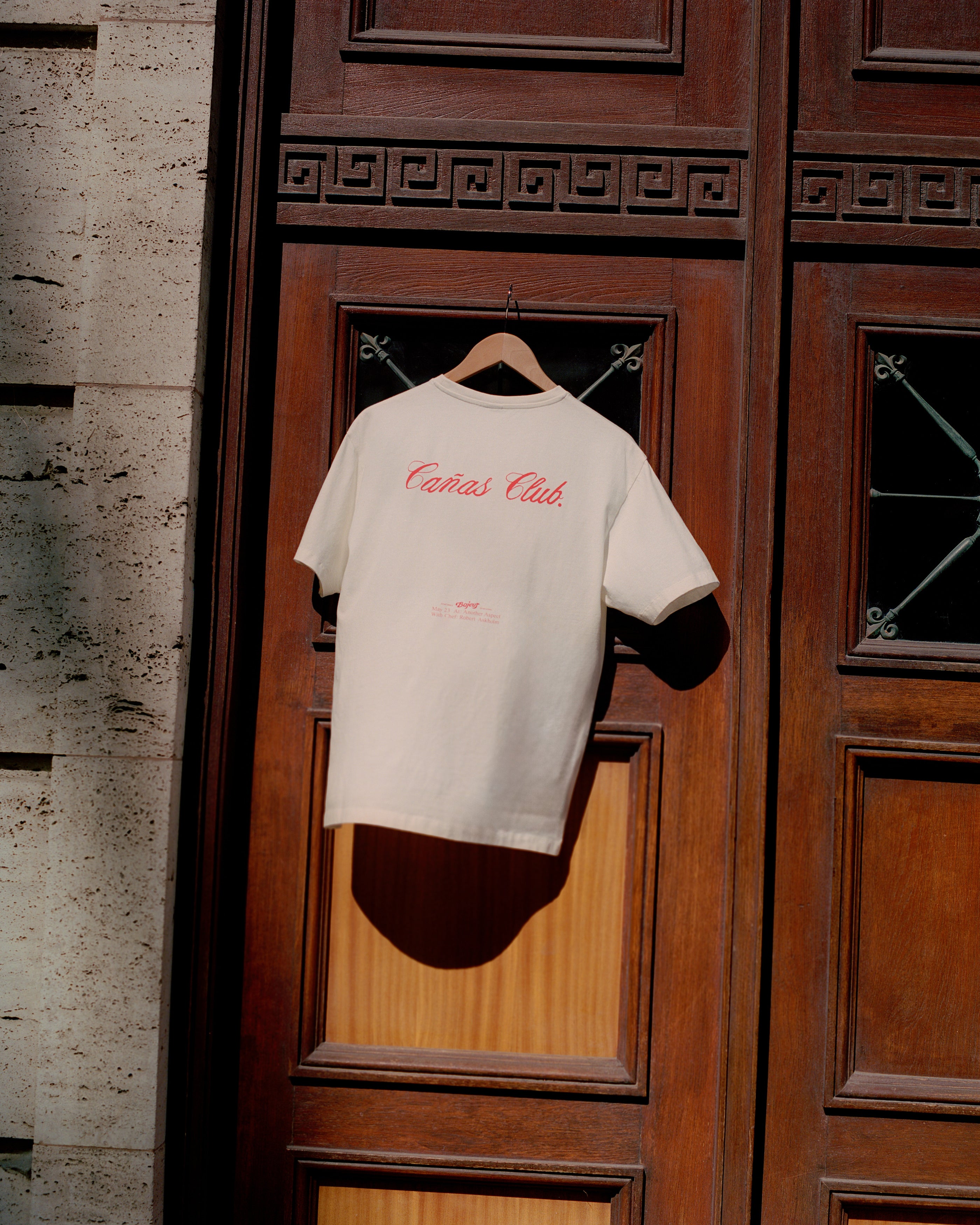 Cañas Club limited edition short-leev t-shirt. Beige with red logos and letters. This picture is from the back of the t-shirt.