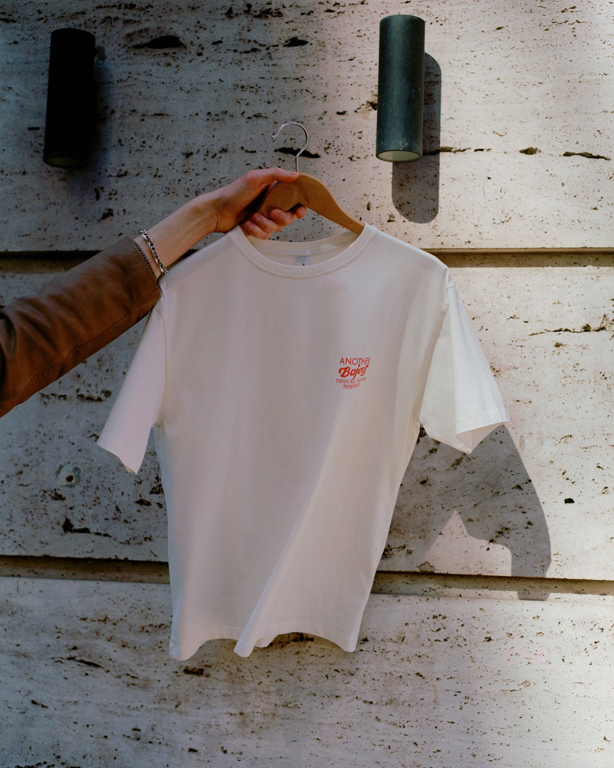 Cañas Club limited edition short-leev t-shirt. Beige with red logos and letters. This picture is from the front of the t-shirt.