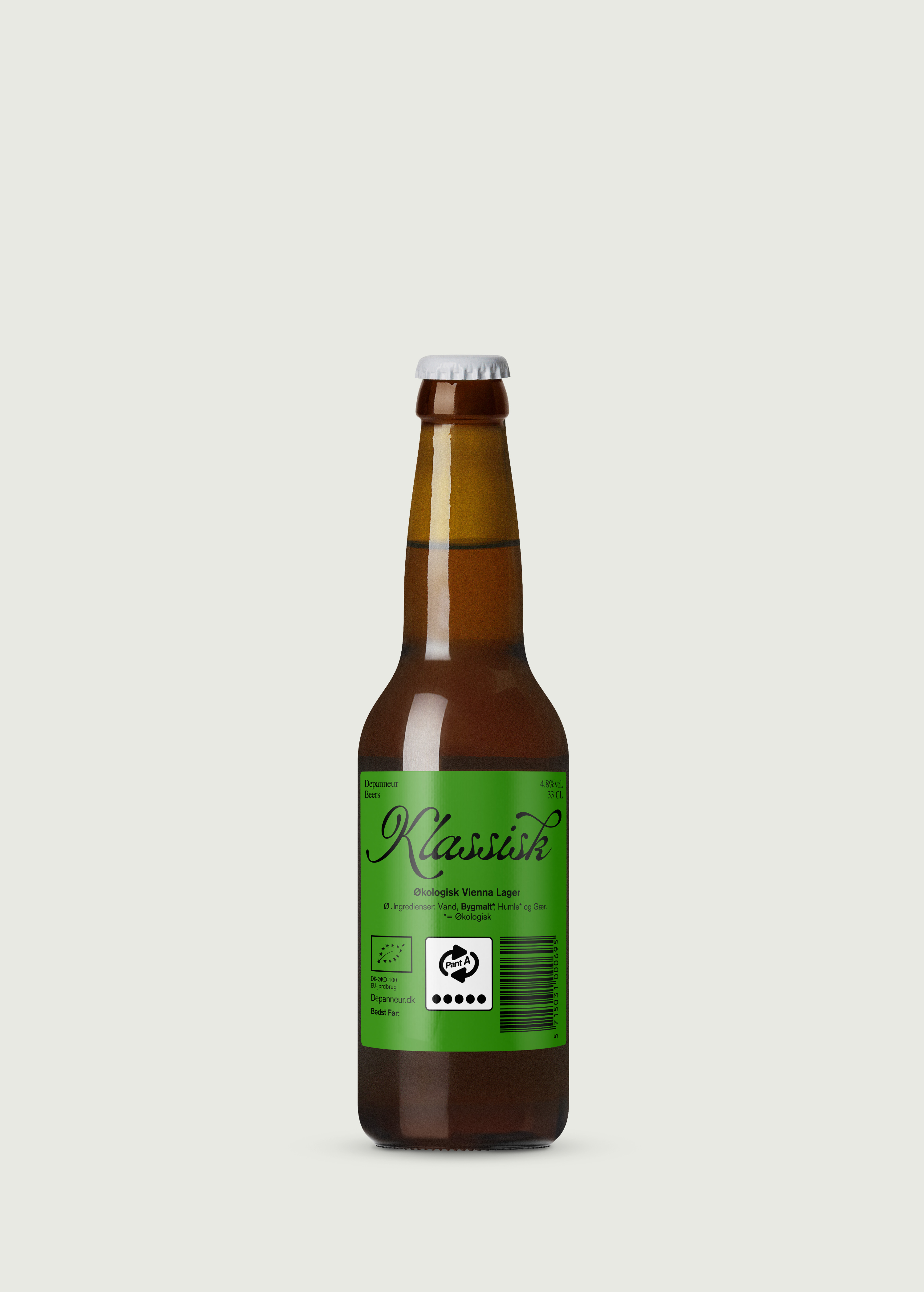A bottle of Klassisk organic Vienna lager with a green label and a visible organic certification logo.