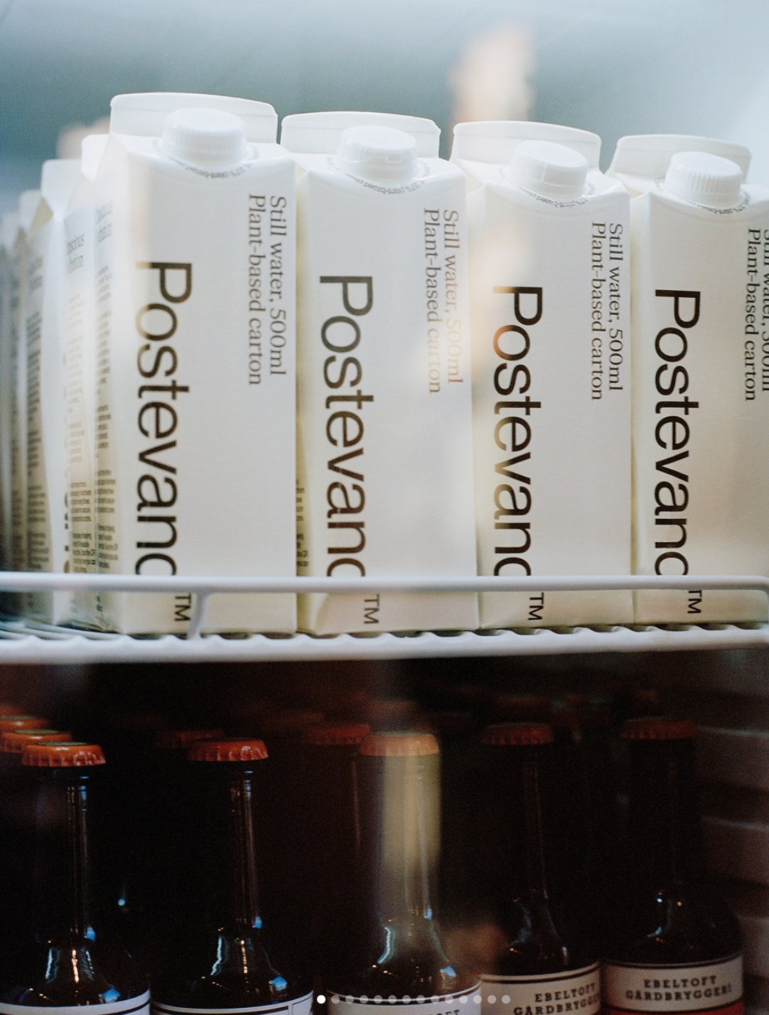 Multiple bottles of Postevand in a fridge with a blurred background