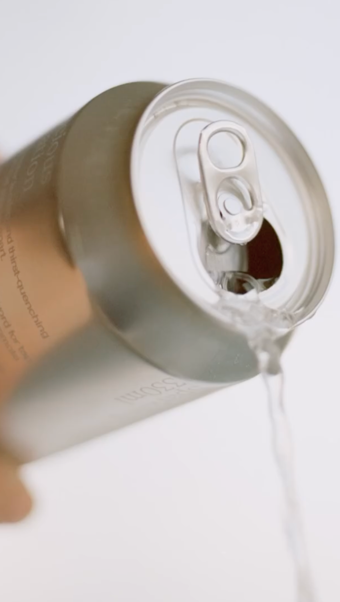 Close-up of a Postvand sparkling being poured with a white background