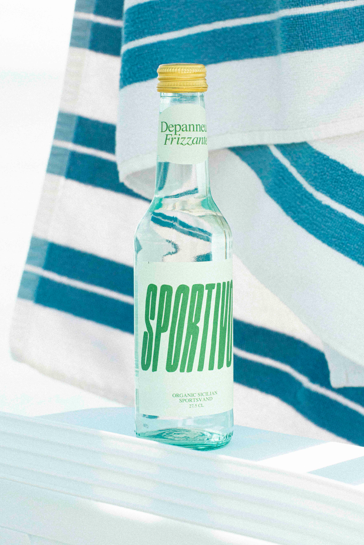 A bottle of Sportivo Organic Sicilian Sports Vand with a towel on the background. 