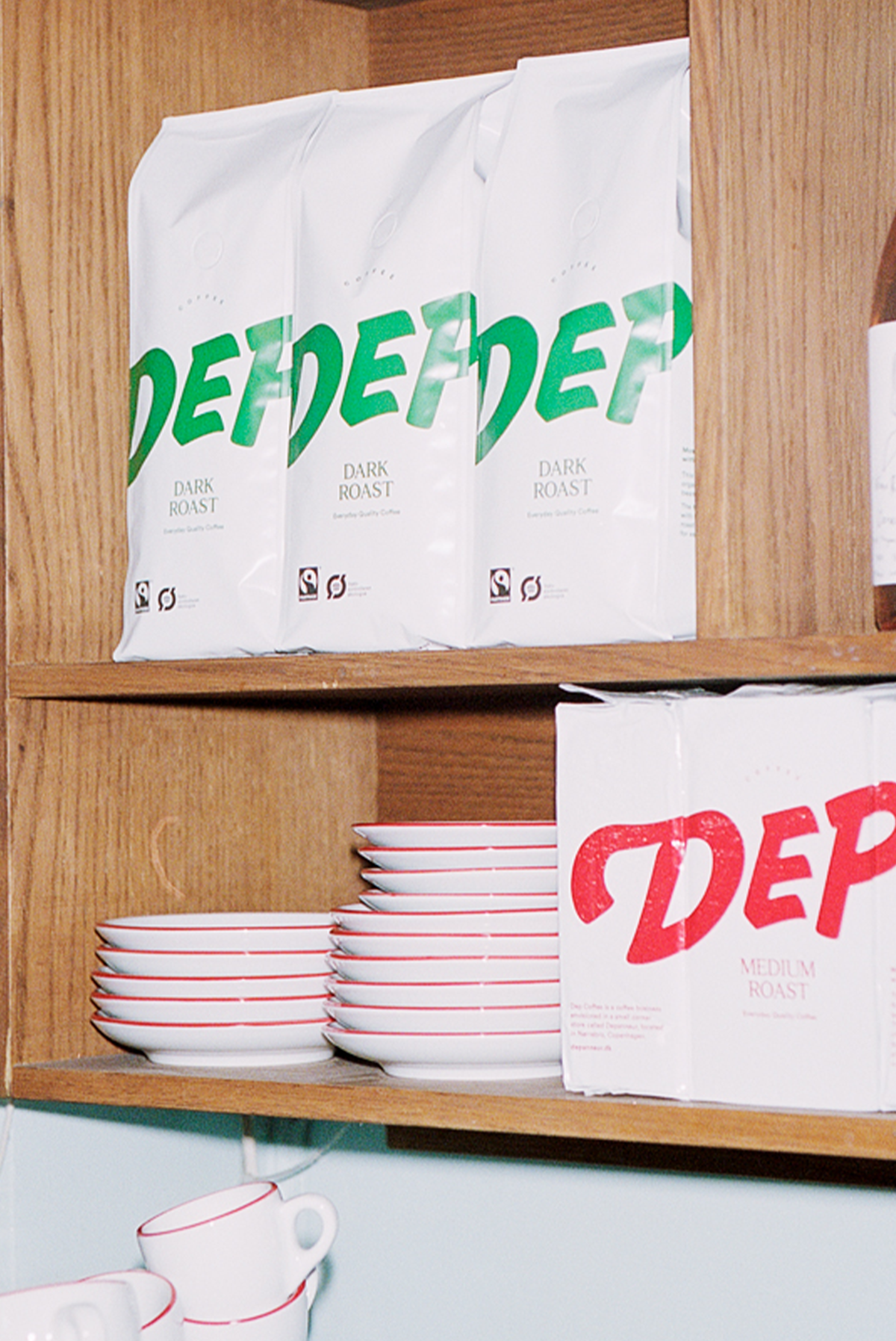 Bags of organic Depanneur dark roast coffee on a shelf in a cafe in Copenhagen. 